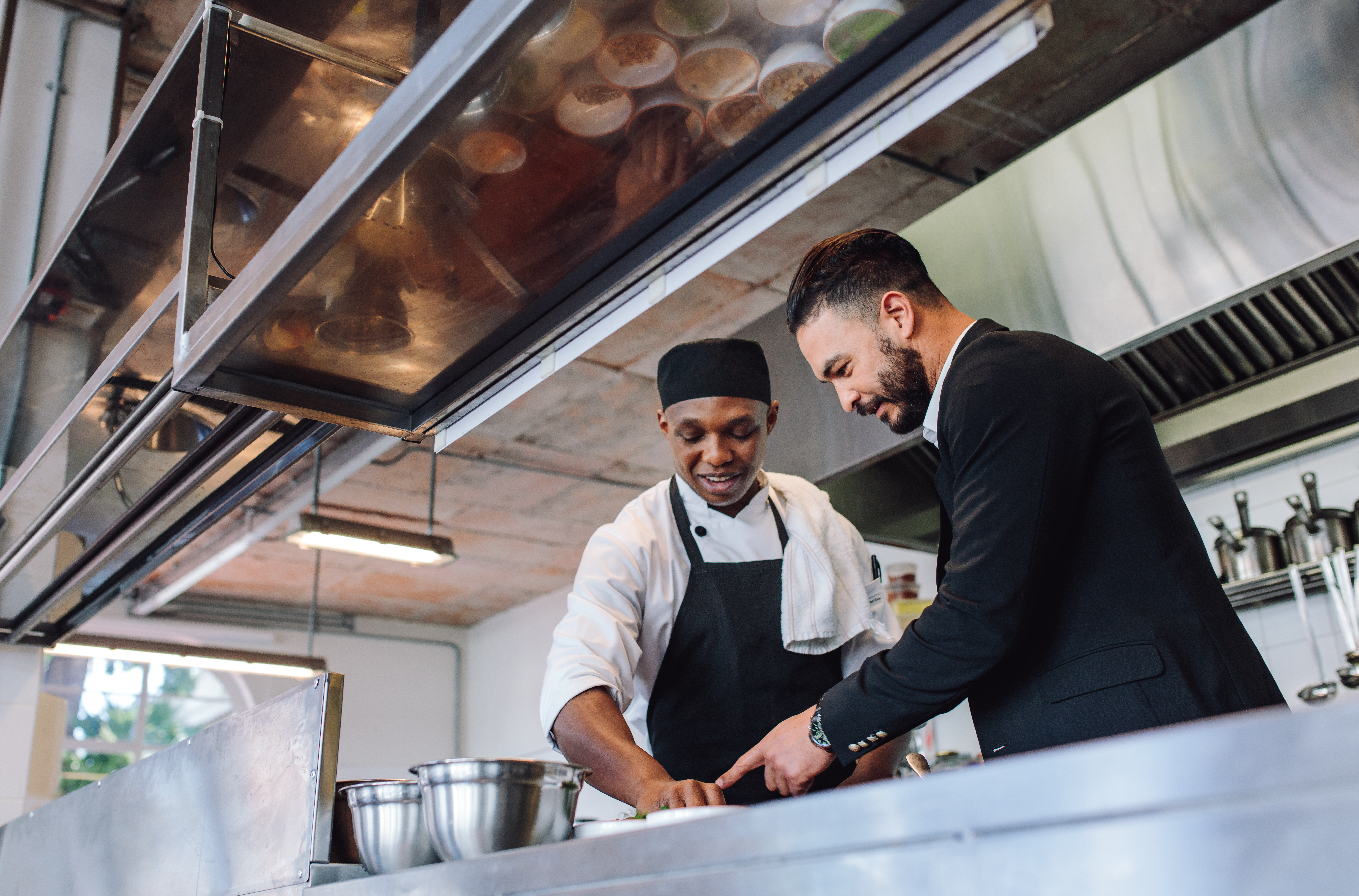 Restaurant manager with chef in kitchen